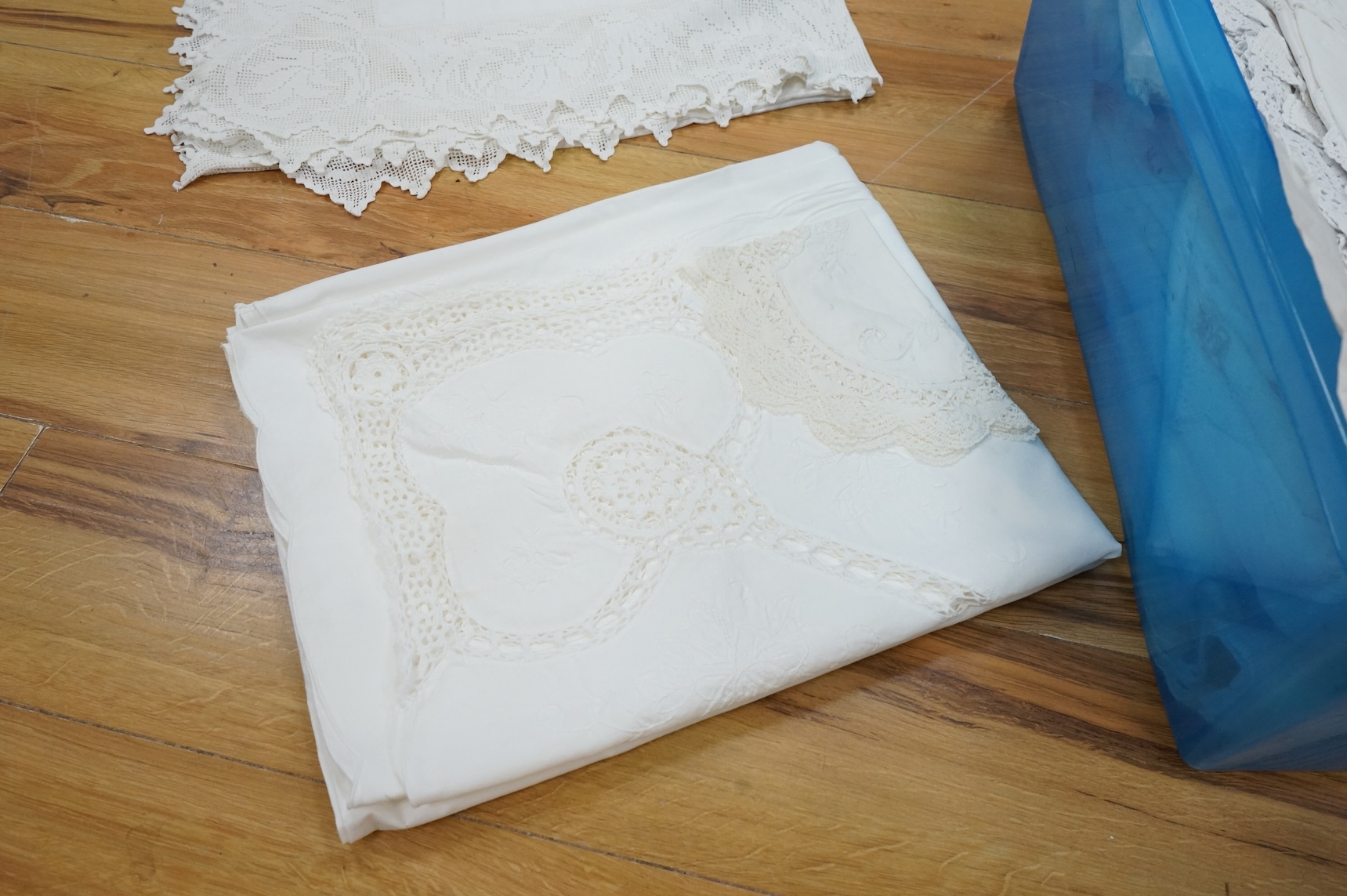 A collection of early 20th century and later crochet, cut work and drawn thread table linens and a large embroidered table cloth